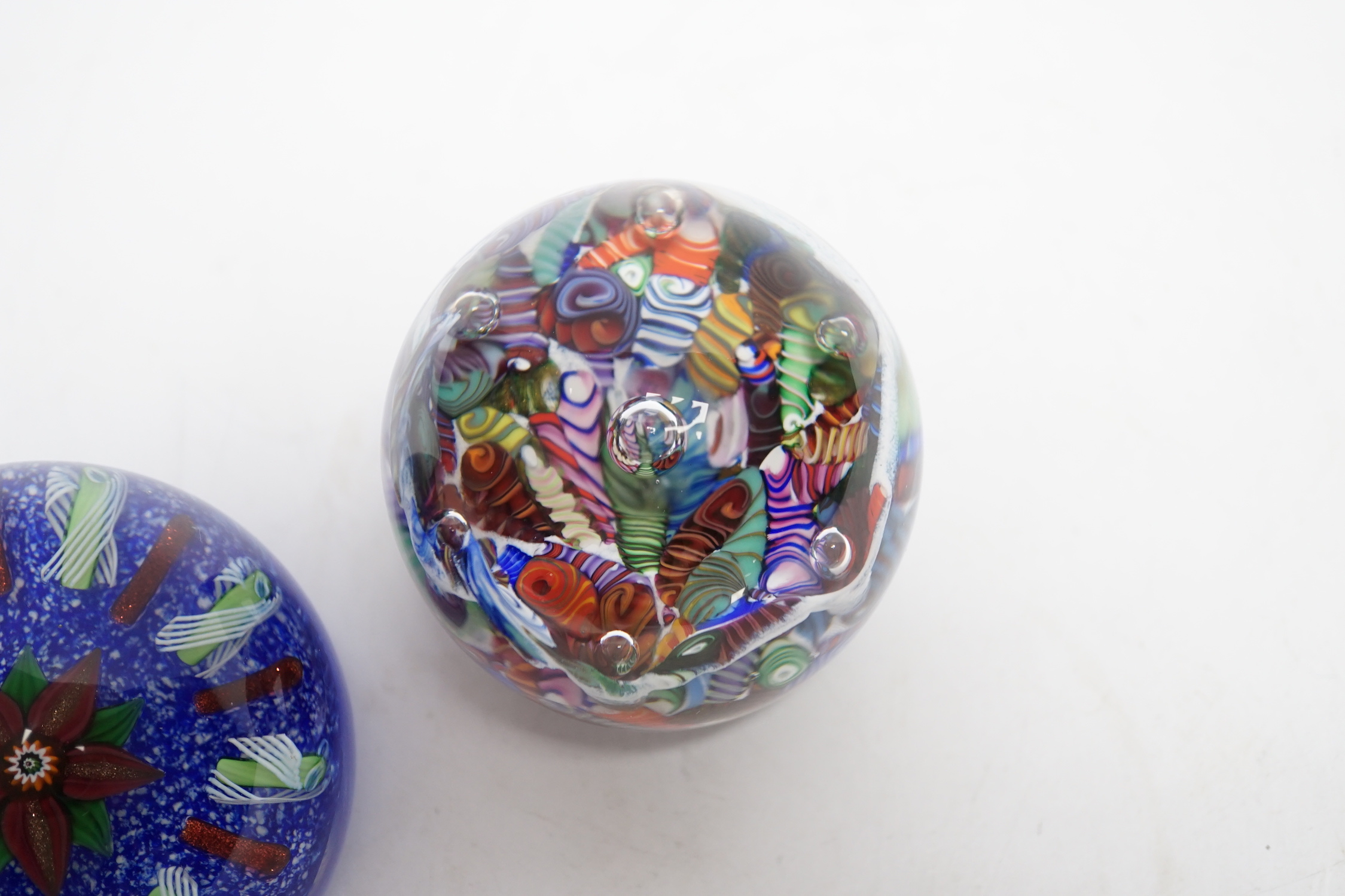 Two Paul Ysart glass paperweight, comprising an anemone surrounded by aventurine and latticino spokes on a blue jasper ground, ‘PY’ cane to underside, 7.5cm, and a ‘Double Harlequin’, PY paper label, 6cm high